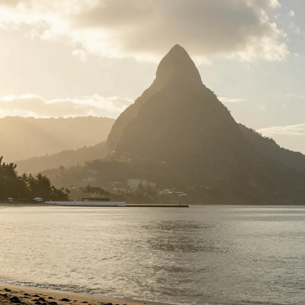Pitons above Soufrière Bay with calm open water and hazy volcanic slopes.