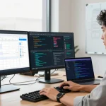 RTI Scheduler interface on dual monitors in a modern office setup showcasing productivity tools and coding.